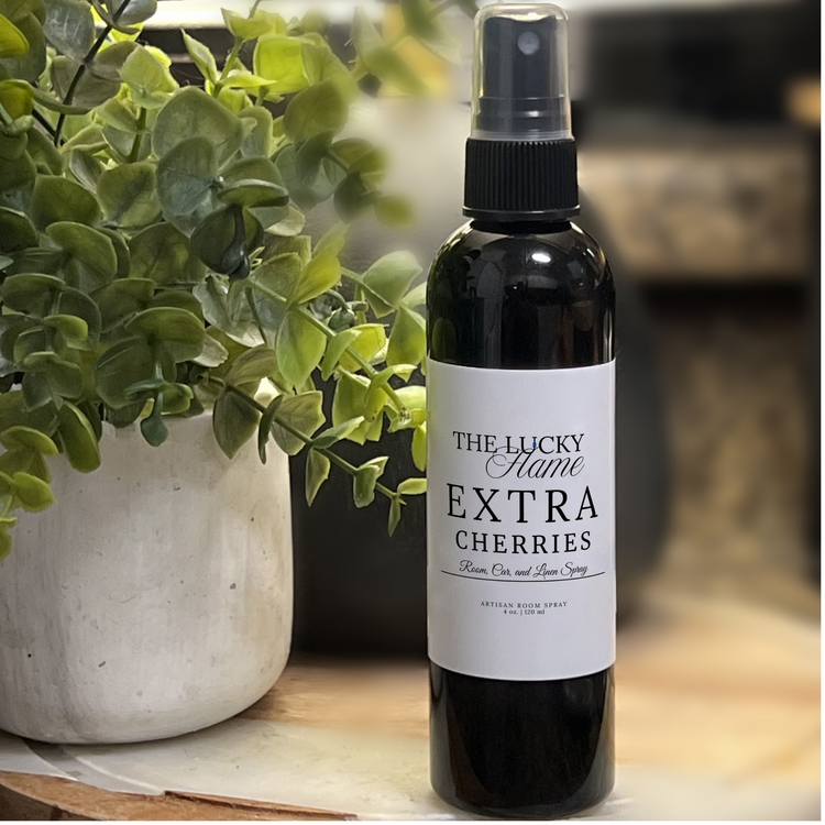 Extra Cherries room, linen, and car spray with notes of juicy peach, fresh strawberries, cherries, and creamy vanilla in a sleek 4 oz black bottle