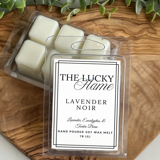Packaged wax melts with 'The Lucky Flame' label on a wooden surface